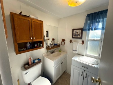 Discover comfort and charm in this beautifully updated 2-bedroom on Lake Henry Golf Club in Florida - for sale on GolfHomes.com, golf home, golf lot
