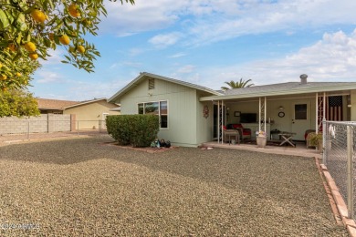 Energy-efficient home in Sun City showcases a large front yard on Sun City Riverview Golf Course in Arizona - for sale on GolfHomes.com, golf home, golf lot