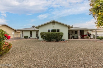 Energy-efficient home in Sun City showcases a large front yard on Sun City Riverview Golf Course in Arizona - for sale on GolfHomes.com, golf home, golf lot