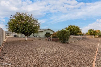 Energy-efficient home in Sun City showcases a large front yard on Sun City Riverview Golf Course in Arizona - for sale on GolfHomes.com, golf home, golf lot