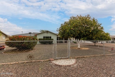 Energy-efficient home in Sun City showcases a large front yard on Sun City Riverview Golf Course in Arizona - for sale on GolfHomes.com, golf home, golf lot