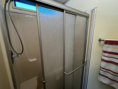 This beautifully maintained 2-bedroom, 2-bathroom Homes of Merit on Lake Henry Golf Club in Florida - for sale on GolfHomes.com, golf home, golf lot