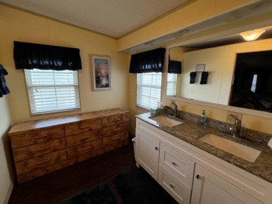 This beautifully maintained 2-bedroom, 2-bathroom Homes of Merit on Lake Henry Golf Club in Florida - for sale on GolfHomes.com, golf home, golf lot