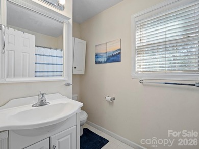 This recently renovated home with an open concept living space on Rumbling Bald Resort on Lake Lure in North Carolina - for sale on GolfHomes.com, golf home, golf lot