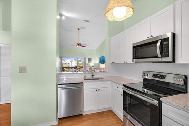 Charming 2BR/2BA condo w/ beautiful lake & golf views, soaring on Pelican Pointe 9 Hole Course in Florida - for sale on GolfHomes.com, golf home, golf lot