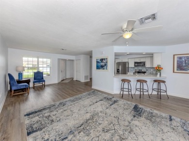 A newly renovated residence with a stunning water view is poised on Sarasota National Golf Club in Florida - for sale on GolfHomes.com, golf home, golf lot