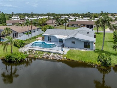 A newly renovated residence with a stunning water view is poised on Sarasota National Golf Club in Florida - for sale on GolfHomes.com, golf home, golf lot