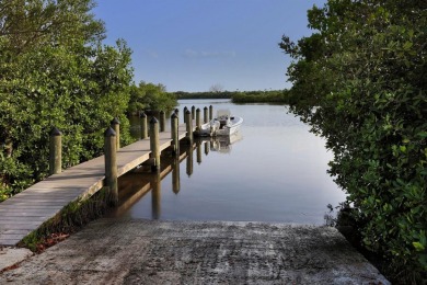 A newly renovated residence with a stunning water view is poised on Sarasota National Golf Club in Florida - for sale on GolfHomes.com, golf home, golf lot