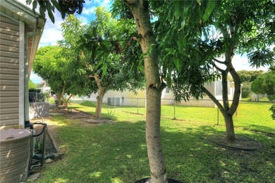 Fruit Trees, Sunshine & Freedom-it's all here on a fenced lot on Barefoot Bay Golf Course in Florida - for sale on GolfHomes.com, golf home, golf lot