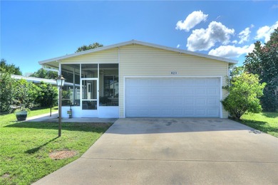 Live the Barefoot Bay lifestyle in this beautifully landscaped on Barefoot Bay Golf Course in Florida - for sale on GolfHomes.com, golf home, golf lot
