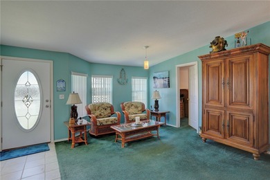 Live the Barefoot Bay lifestyle in this beautifully landscaped on Barefoot Bay Golf Course in Florida - for sale on GolfHomes.com, golf home, golf lot
