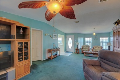 Live the Barefoot Bay lifestyle in this beautifully landscaped on Barefoot Bay Golf Course in Florida - for sale on GolfHomes.com, golf home, golf lot