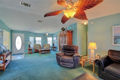 Live the Barefoot Bay lifestyle in this beautifully landscaped on Barefoot Bay Golf Course in Florida - for sale on GolfHomes.com, golf home, golf lot