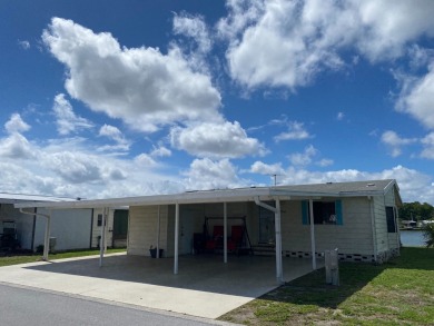 THIS TRIPLE WIDE LAKE FRONT HOME LOCATED IN THE ALL AGES SILVER on Silver Dollar Golf and Trap Club in Florida - for sale on GolfHomes.com, golf home, golf lot