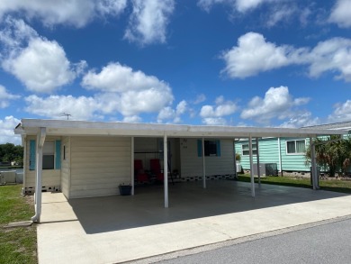 THIS TRIPLE WIDE LAKE FRONT HOME LOCATED IN THE ALL AGES SILVER on Silver Dollar Golf and Trap Club in Florida - for sale on GolfHomes.com, golf home, golf lot