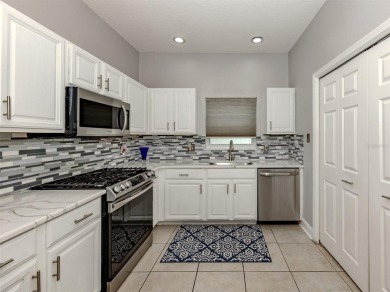 A charming three-bedroom, two-bath, desirable two-car side entry on The River Club in Florida - for sale on GolfHomes.com, golf home, golf lot