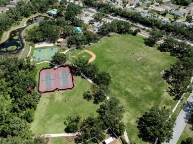 A charming three-bedroom, two-bath, desirable two-car side entry on The River Club in Florida - for sale on GolfHomes.com, golf home, golf lot