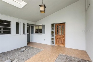 Tucked inside a charming Cul de sac, this 3 bedroom, 2 bath plus on The Dunedin Country Club in Florida - for sale on GolfHomes.com, golf home, golf lot