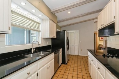 Tucked inside a charming Cul de sac, this 3 bedroom, 2 bath plus on The Dunedin Country Club in Florida - for sale on GolfHomes.com, golf home, golf lot