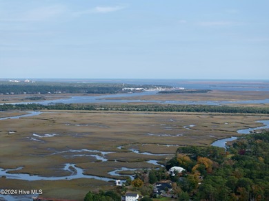 Build your beach house on this lovely lot with marsh views and on Oak Island Golf Club in North Carolina - for sale on GolfHomes.com, golf home, golf lot