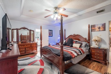 Located in the gated community of Hideaway Lake, this inviting on Hide-A-Way Lake Golf Course in Texas - for sale on GolfHomes.com, golf home, golf lot