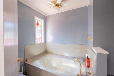 Located in the gated community of Hideaway Lake, this inviting on Hide-A-Way Lake Golf Course in Texas - for sale on GolfHomes.com, golf home, golf lot