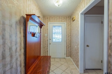 Located in the gated community of Hideaway Lake, this inviting on Hide-A-Way Lake Golf Course in Texas - for sale on GolfHomes.com, golf home, golf lot
