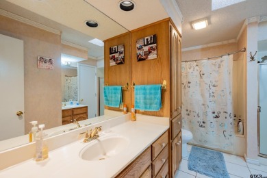 Located in the gated community of Hideaway Lake, this inviting on Hide-A-Way Lake Golf Course in Texas - for sale on GolfHomes.com, golf home, golf lot