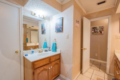 Located in the gated community of Hideaway Lake, this inviting on Hide-A-Way Lake Golf Course in Texas - for sale on GolfHomes.com, golf home, golf lot
