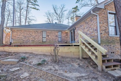 Located in the gated community of Hideaway Lake, this inviting on Hide-A-Way Lake Golf Course in Texas - for sale on GolfHomes.com, golf home, golf lot