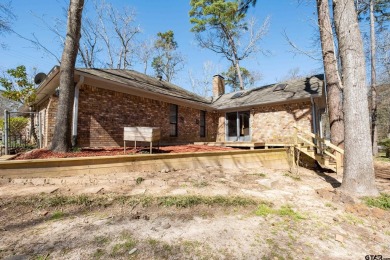 Located in the gated community of Hideaway Lake, this inviting on Hide-A-Way Lake Golf Course in Texas - for sale on GolfHomes.com, golf home, golf lot