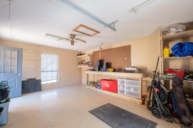 Located in the gated community of Hideaway Lake, this inviting on Hide-A-Way Lake Golf Course in Texas - for sale on GolfHomes.com, golf home, golf lot