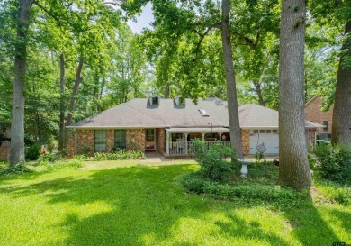Located in the gated community of Hideaway Lake, this inviting on Hide-A-Way Lake Golf Course in Texas - for sale on GolfHomes.com, golf home, golf lot