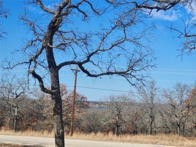 Beautiful corner lot build site with lake views and mature oak on Nocona Hills Golf Course in Texas - for sale on GolfHomes.com, golf home, golf lot