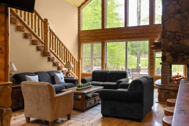 Stunning, custom-built log home overlooking the 16th tee & on Cedar River Golf Course in Michigan - for sale on GolfHomes.com, golf home, golf lot