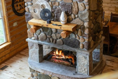 Stunning, custom-built log home overlooking the 16th tee & on Cedar River Golf Course in Michigan - for sale on GolfHomes.com, golf home, golf lot