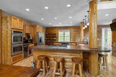 Stunning, custom-built log home overlooking the 16th tee & on Cedar River Golf Course in Michigan - for sale on GolfHomes.com, golf home, golf lot