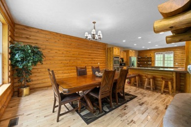Stunning, custom-built log home overlooking the 16th tee & on Cedar River Golf Course in Michigan - for sale on GolfHomes.com, golf home, golf lot