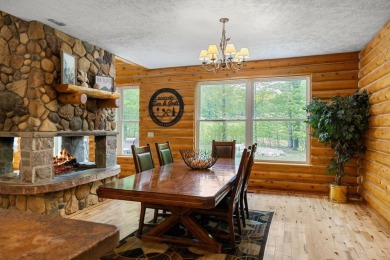 Stunning, custom-built log home overlooking the 16th tee & on Cedar River Golf Course in Michigan - for sale on GolfHomes.com, golf home, golf lot