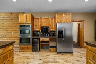 Stunning, custom-built log home overlooking the 16th tee & on Cedar River Golf Course in Michigan - for sale on GolfHomes.com, golf home, golf lot