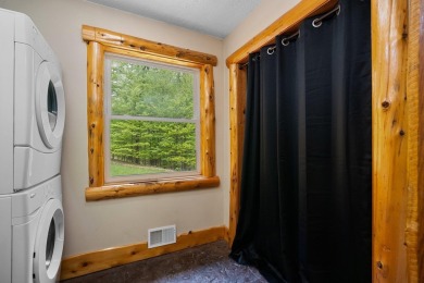 Stunning, custom-built log home overlooking the 16th tee & on Cedar River Golf Course in Michigan - for sale on GolfHomes.com, golf home, golf lot