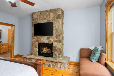 Stunning, custom-built log home overlooking the 16th tee & on Cedar River Golf Course in Michigan - for sale on GolfHomes.com, golf home, golf lot