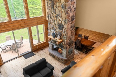 Stunning, custom-built log home overlooking the 16th tee & on Cedar River Golf Course in Michigan - for sale on GolfHomes.com, golf home, golf lot