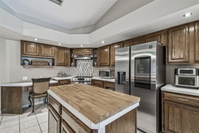 Stunning 4BR/2.5BA pool home on an oversized lot in the gated on East Lake Woodlands Country Club in Florida - for sale on GolfHomes.com, golf home, golf lot