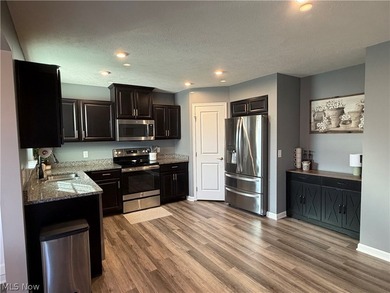 Welcome to your dream home! Tucked away in a charming cul-de-sac on Grey Hawk Golf Club in Ohio - for sale on GolfHomes.com, golf home, golf lot