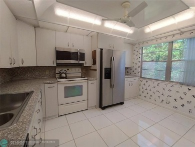 BRIGHT & SPACIOUS CORNER OVERLOOKING THE POOL AREA & SURROUNDING on Wynmoor Golf Course in Florida - for sale on GolfHomes.com, golf home, golf lot