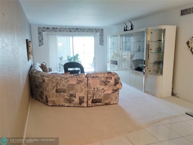 BRIGHT & SPACIOUS CORNER OVERLOOKING THE POOL AREA & SURROUNDING on Wynmoor Golf Course in Florida - for sale on GolfHomes.com, golf home, golf lot
