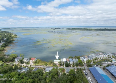 Located on the serene salt marsh with sweeping deep-water views on Ocean Creek Golf Course in South Carolina - for sale on GolfHomes.com, golf home, golf lot