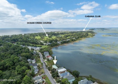 Located on the serene salt marsh with sweeping deep-water views on Ocean Creek Golf Course in South Carolina - for sale on GolfHomes.com, golf home, golf lot