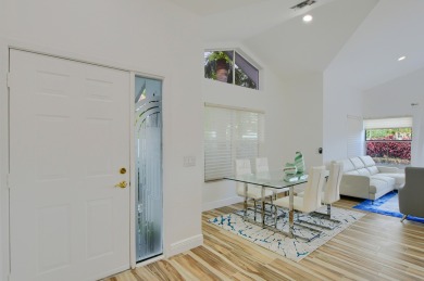 This contemporary one-story townhouse is sold furnished on Broken Sound Golf and Club  in Florida - for sale on GolfHomes.com, golf home, golf lot